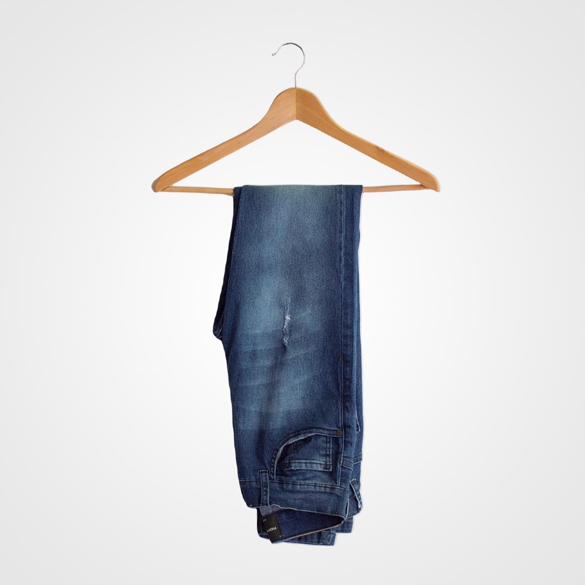 Pair of stylish blue denim jeans hanging on a wooden hanger, perfect for casual or semi-formal wear. Ideal for fashion-forward brides or bridal party accessories.