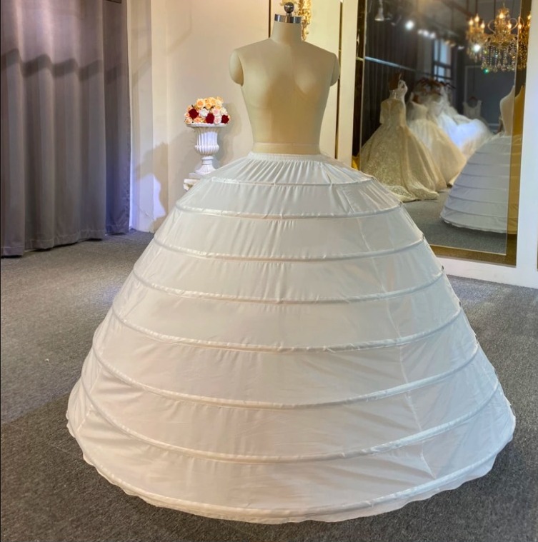 Enhance your bridal gown with our 8-hoop petticoat – a must-have for achieving the perfect silhouette. This petticoat adds graceful volume and structure, ensuring your dress drapes with elegance. Elevate your wedding day look with this essential accessory. 💃✨ #BridalPetticoat #WeddingFashion #EnhanceYourSilhouette