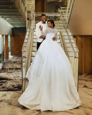 Elegant ivory A-line bridal gown with lace. Affordable Wedding Gowns and Bridal Dresses appliqué and long sleeve