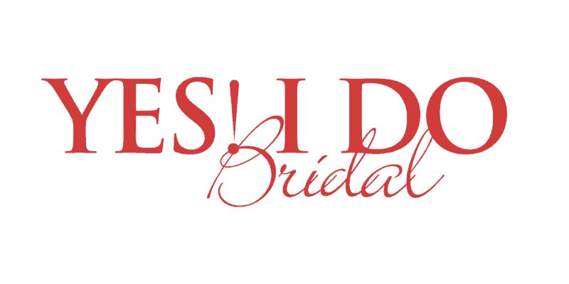 A stunning white bridal gown with intricate lace details and a flowing train, perfect for a wedding day. Designed by Yes I Do Bridal, emphasizing elegance and craftsmanship for brides-to-be.